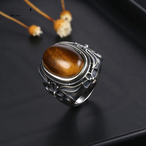 Close-up of Floral Majesty Tiger Eye Stone Ring with intricate silver floral engravings