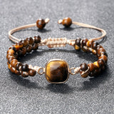 Detailed view of the polished Tiger Eye beads and charm on the bracelet
