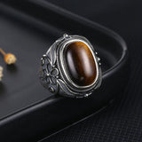 Elegant Tiger Eye Stone Ring with detailed floral engravings on a silver band