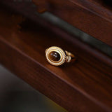 Detailed view showing the adjustable mechanism on the 18k gold band of the women's Tiger Eye ring