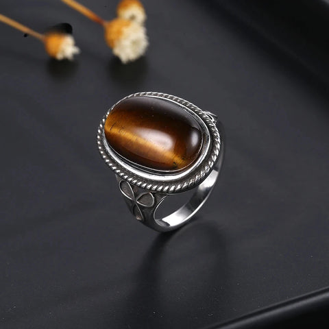 Close-up of Trinity Clover Signature Tiger Eye Silver Ring on a display