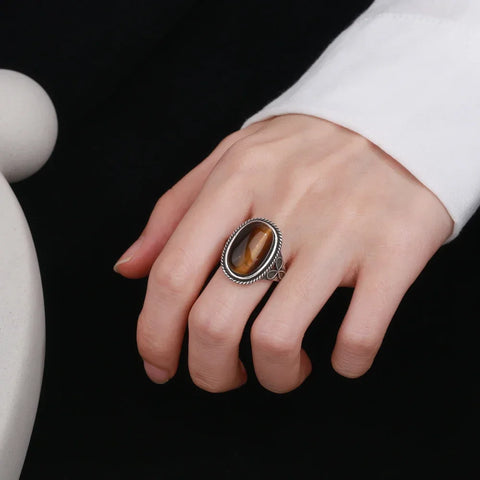 Woman's hand wearing the Trinity Clover Signature Tiger Eye Silver Ring